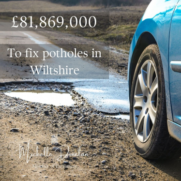 Car on a road with a pothole 